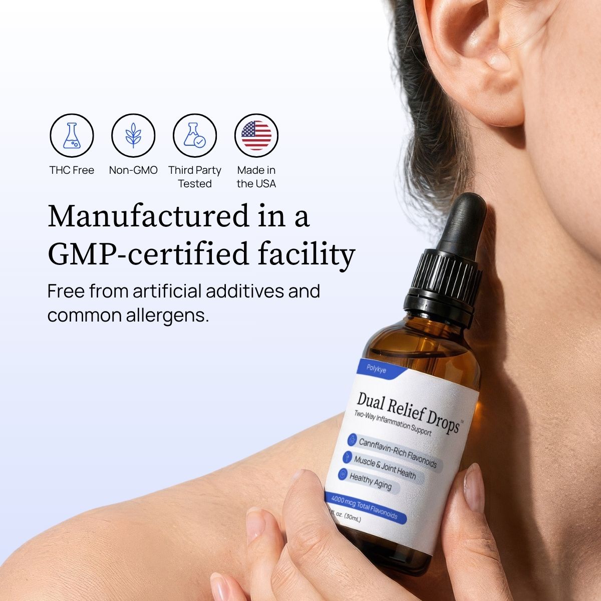 A person holding a bottle of Dual Relief™ Drops against their shoulder, with marketing text and icons about THC-free, non-GMO, third-party tested, and made in the USA on a light background.